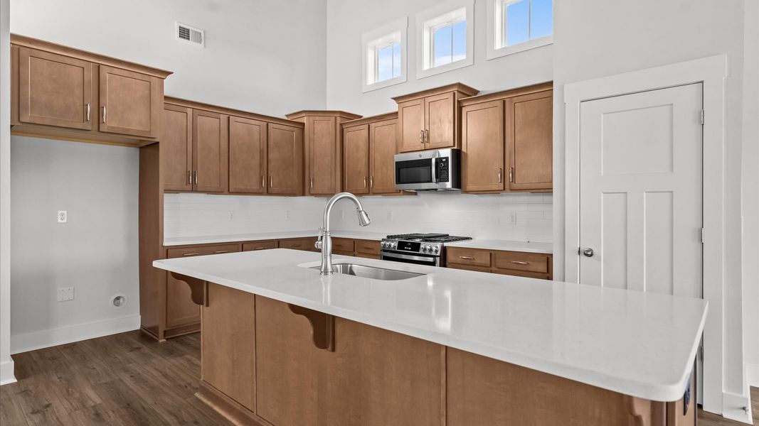 Accomplished kitchen design featuring a statement island for both prep and gathering