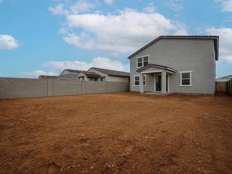 A house with a dirt yard.