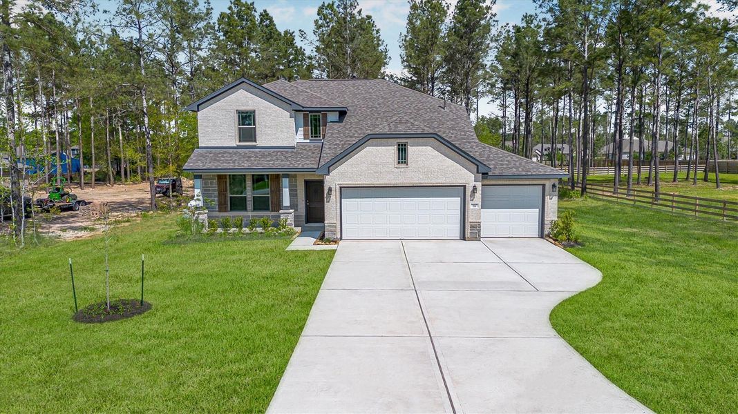 Front exterior of a new home in Deer Pines, Conroe, TX, highlighting curb appeal (Image 25).