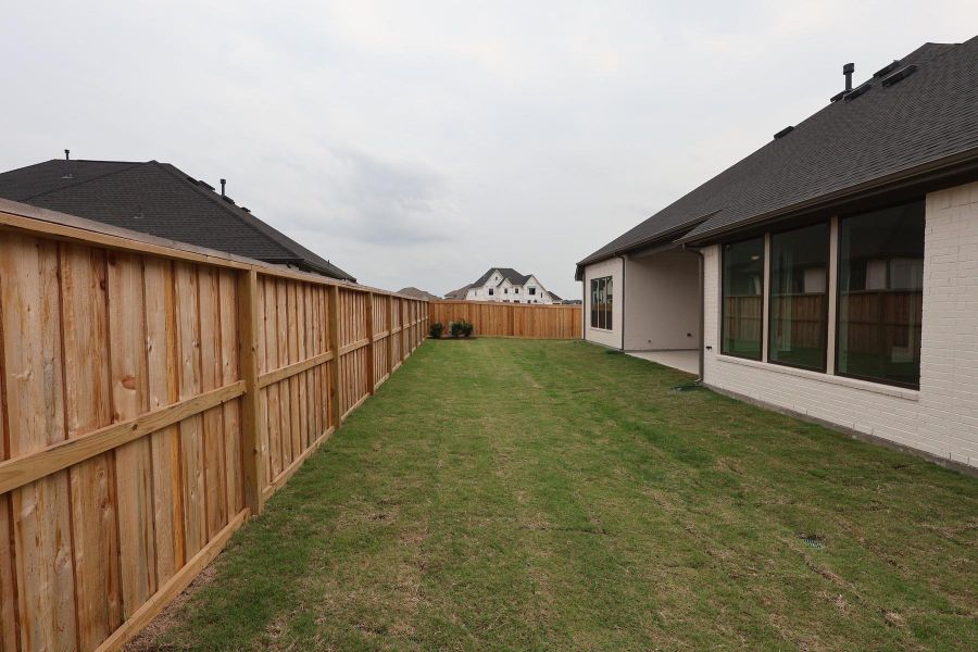 Exterior details and patio area of a home in Dunham Pointe, Cypress (Image 19). Exterior details and patio area of a home in Dunham Pointe, Cypress (Image 19).