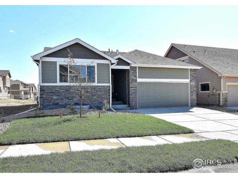 Front exterior of a new home in Southridge, Johnstown, CO, highlighting curb appeal (Image 1).