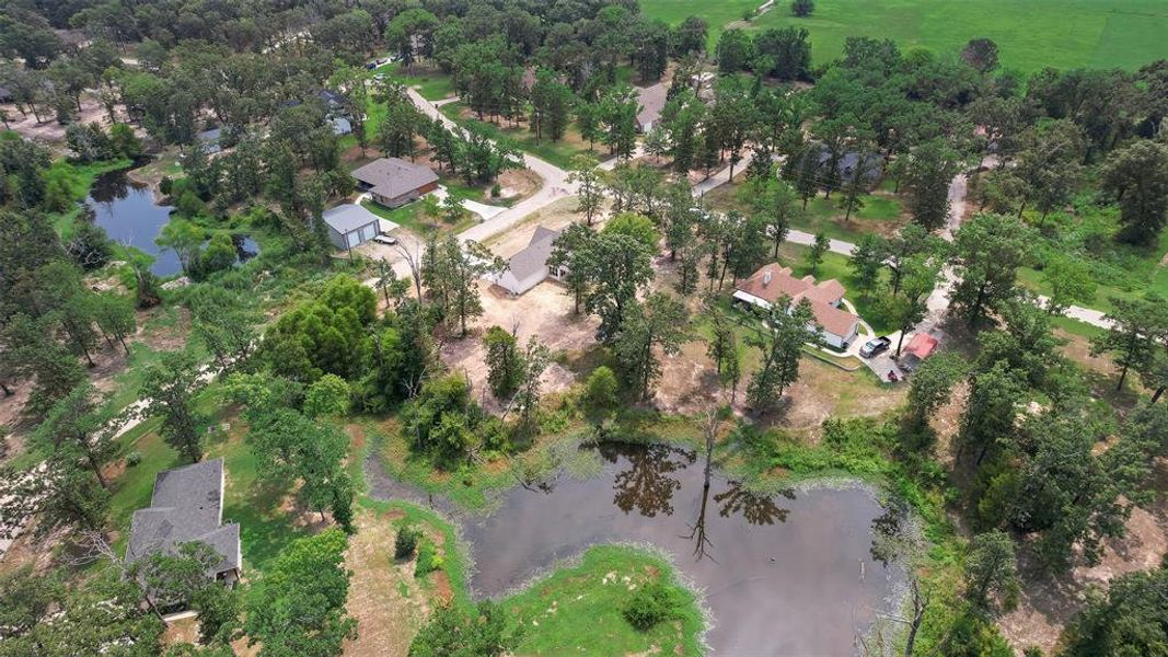 Aerial view of property's location featuring a nearby body of water and nearby suburban area