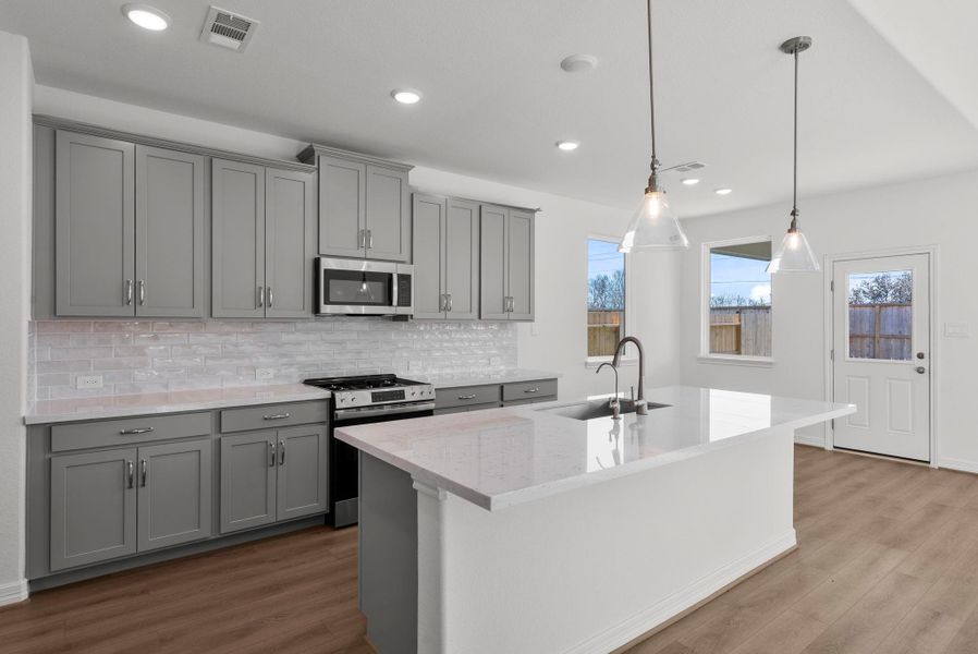 Bright and inviting, this kitchen opens seamlessly to a cozy breakfast nook, filled with natural light—an ideal space for casual dining and morning coffee.