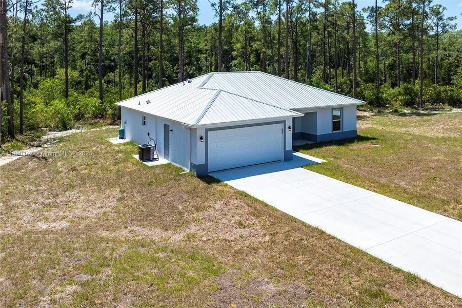 Front exterior of a new home in , Lehigh Acres, FL, highlighting curb appeal (Image 13).