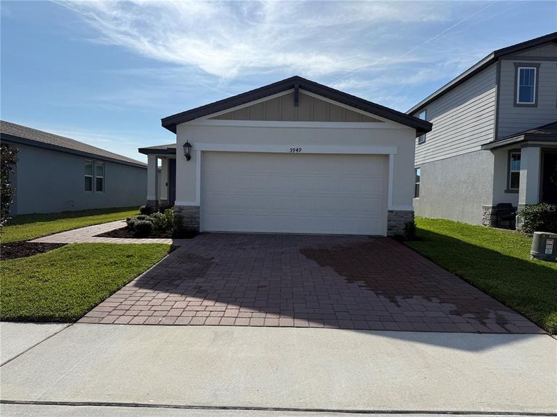 Front exterior of a new home in , Haines City, FL, highlighting curb appeal (Image 1). Front exterior of a new home in , Haines City, FL, highlighting curb appeal (Image 1).