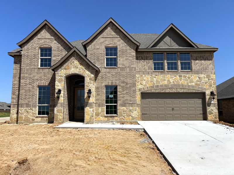 Front exterior of a new home in Mockingbird Hills, Joshua, TX, highlighting curb appeal (Image 23).