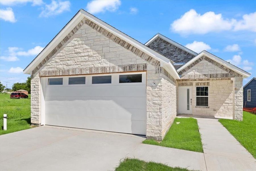 Front exterior of a new home in , Royse City, TX, highlighting curb appeal (Image 1). Front exterior of a new home in , Royse City, TX, highlighting curb appeal (Image 1).