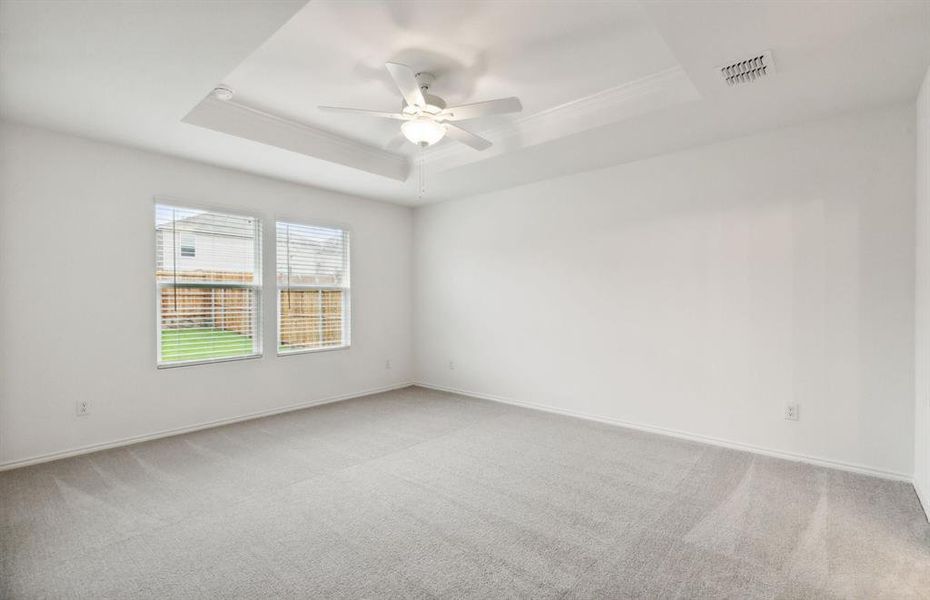 Elegant owner's suite with Tray ceiling *real home pictured