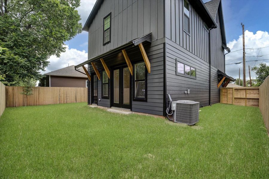 Spacious backyard ideal for entertaining or children's play area. The exterior features pre-wired outdoor speakers and convenient exterior power outlets to enhance your outdoor living experience.