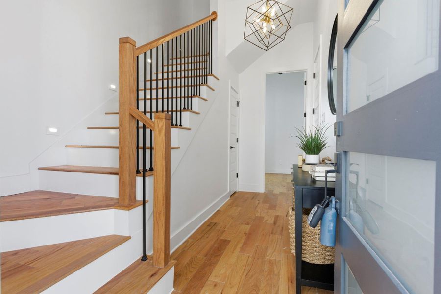 Step inside to a welcoming entry that leads to a private first-floor bedroom, offering convenience and separation from the main living areas.