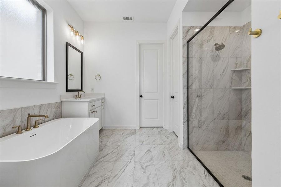 Featuring a beautiful free standing tub and oversized walk in shower, this owner's bath is the perfect place to start or end your day!