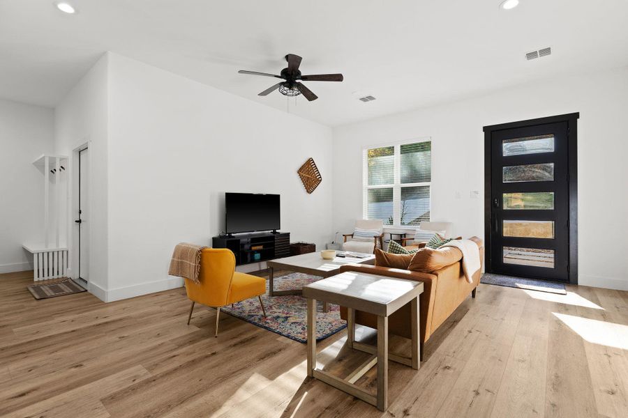 Living area featuring recessed lighting, a ceiling fan, and light wood-style flooring