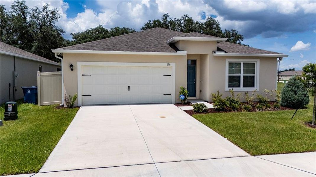 Front exterior of a new home in , Davenport, FL, highlighting curb appeal (Image 21). Front exterior of a new home in , Davenport, FL, highlighting curb appeal (Image 21).