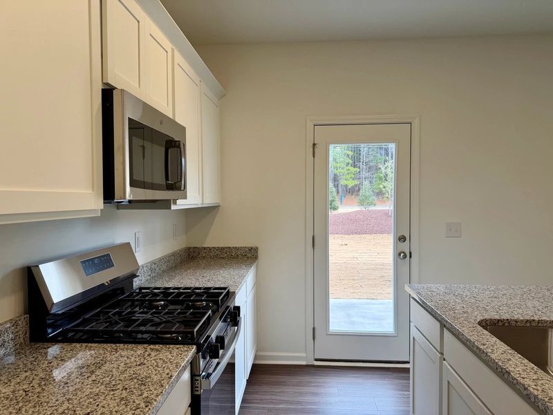 Kitchen - Chic white finishes and smooth surfaces shine.