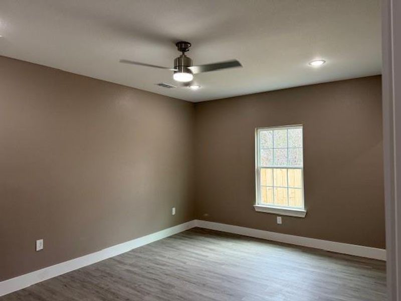 Empty room featuring a ceiling fan, wood finished floors, baseboards, and recessed lighting Empty room featuring a ceiling fan, wood finished floors, baseboards, and recessed lighting