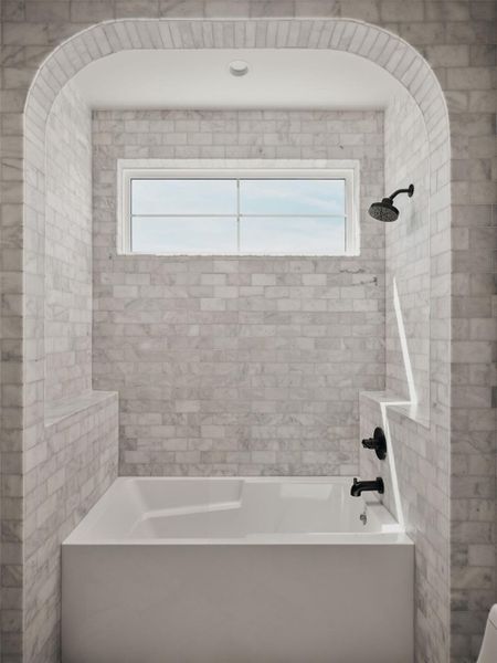 Full bathroom featuring shower / bathtub combination and healthy amount of natural light