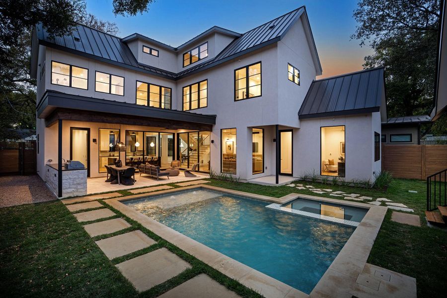 Bounded by gray lueders limestone, the pool is the shimmering focal point of the back yard.