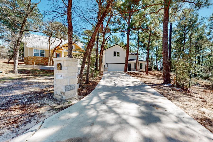 Front exterior of a new home in , Bastrop, TX, highlighting curb appeal (Image 1).