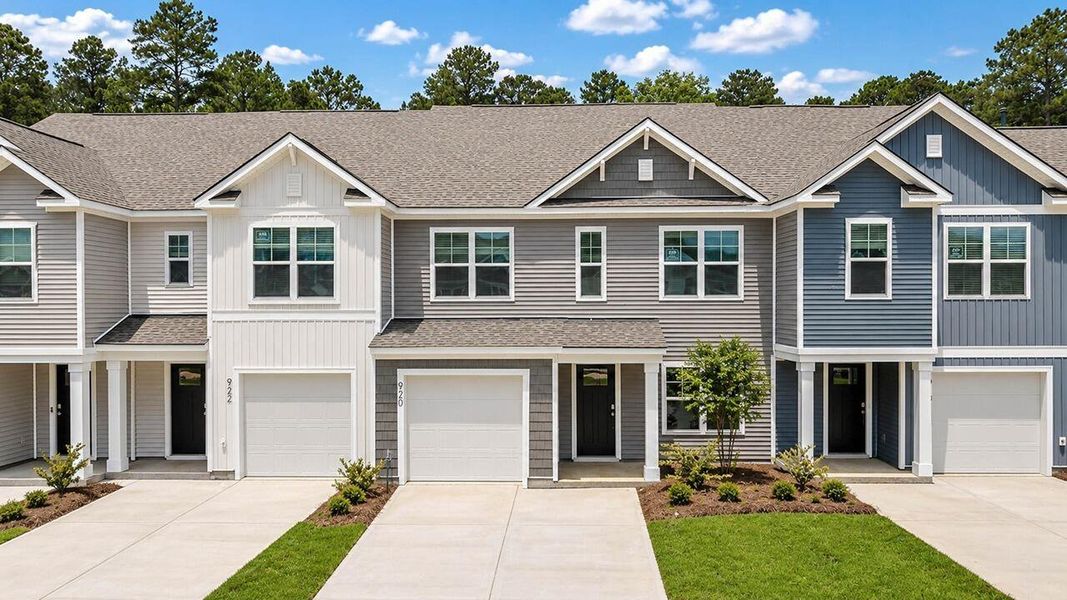 Front exterior of a new home in Pine Hills Townhomes at Cane Bay, Summerville, SC, highlighting curb appeal (Image 1). Front exterior of a new home in Pine Hills Townhomes at Cane Bay, Summerville, SC, highlighting curb appeal (Image 1).