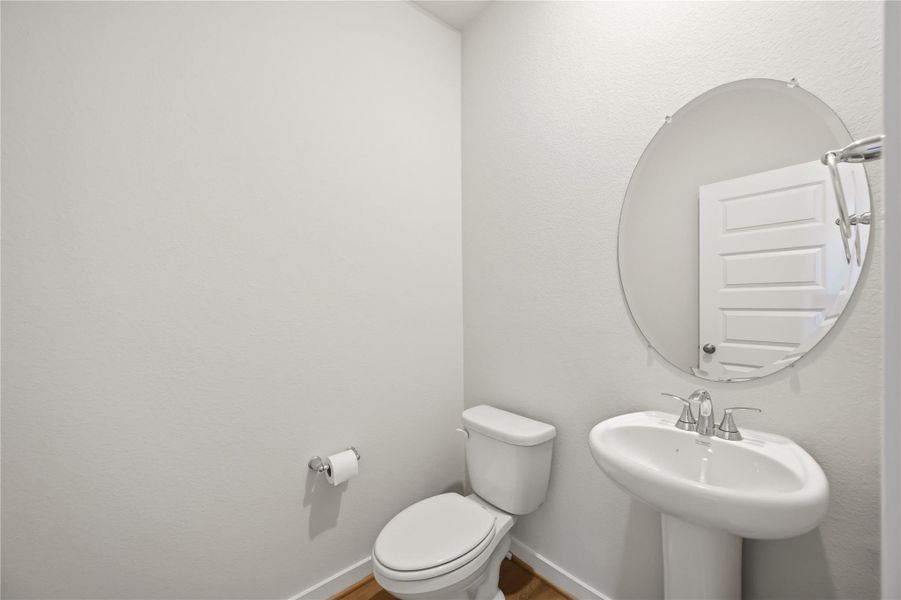 Half bath located by stairs on bottom floor. Half bath located by stairs on bottom floor.