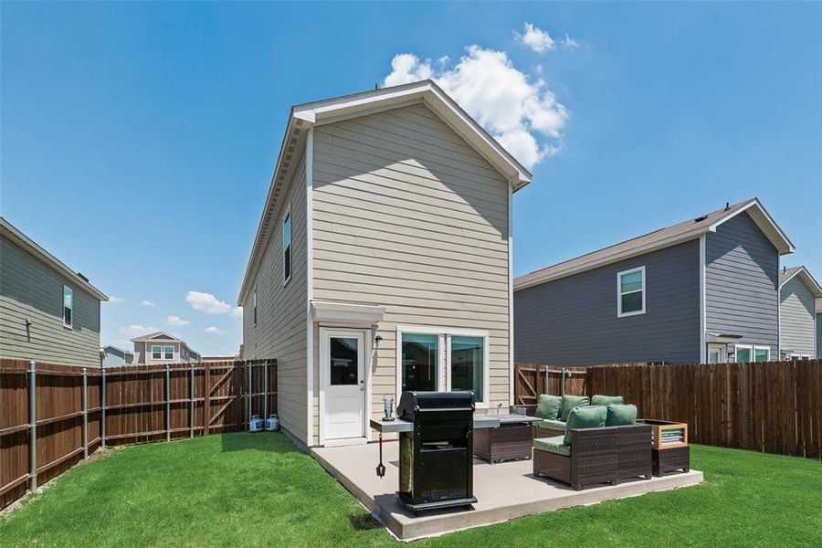 Back of house featuring an outdoor living space, a fenced backyard, and a patio Back of house featuring an outdoor living space, a fenced backyard, and a patio