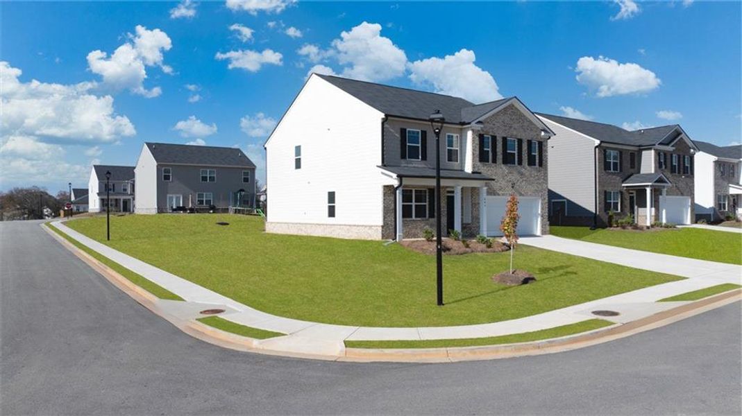 Front exterior of a new home in The Reserve at Calcutta, Stockbridge, GA, highlighting curb appeal (Image 23). Front exterior of a new home in The Reserve at Calcutta, Stockbridge, GA, highlighting curb appeal (Image 23).