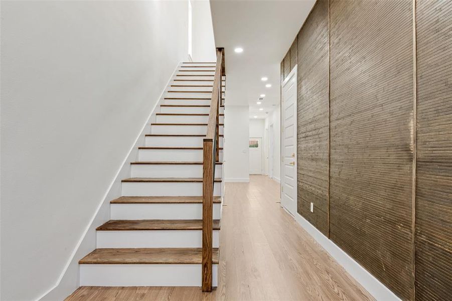 Stairs featuring recessed lighting and wood finished floors Stairs featuring recessed lighting and wood finished floors