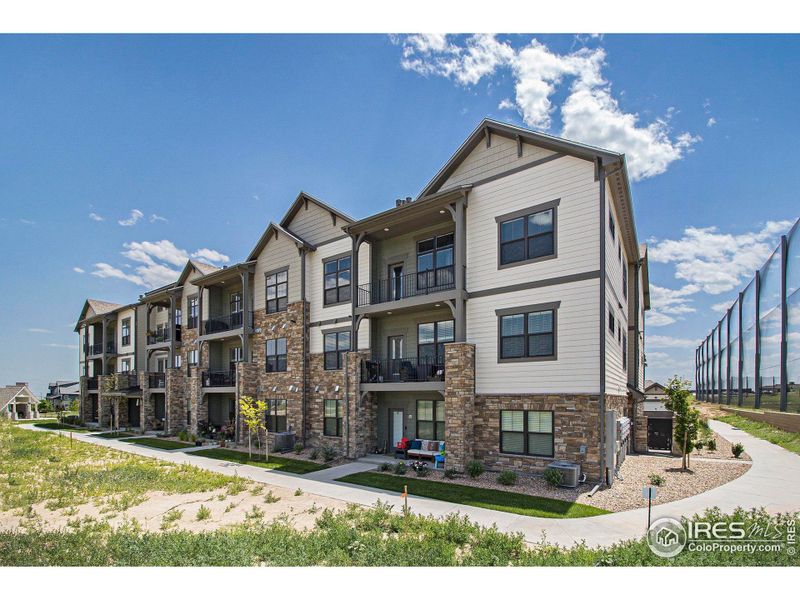 Front exterior of a new home in Highlands at Fox Hill - The Flats, Longmont, CO, highlighting curb appeal (Image 1). Front exterior of a new home in Highlands at Fox Hill - The Flats, Longmont, CO, highlighting curb appeal (Image 1).