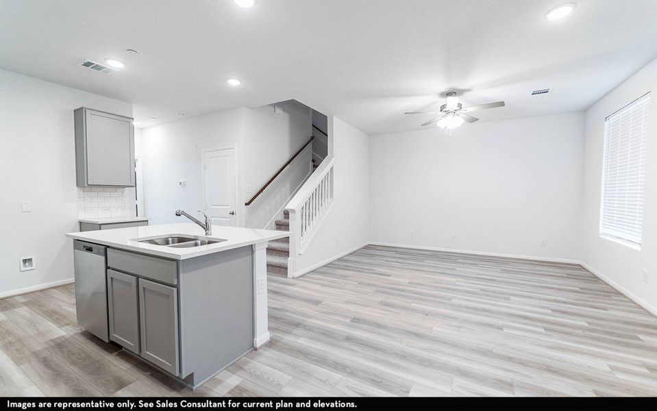 Kitchen with gray cabinetry, a kitchen island with sink, a ceiling fan, stainless steel dishwasher, and recessed lighting