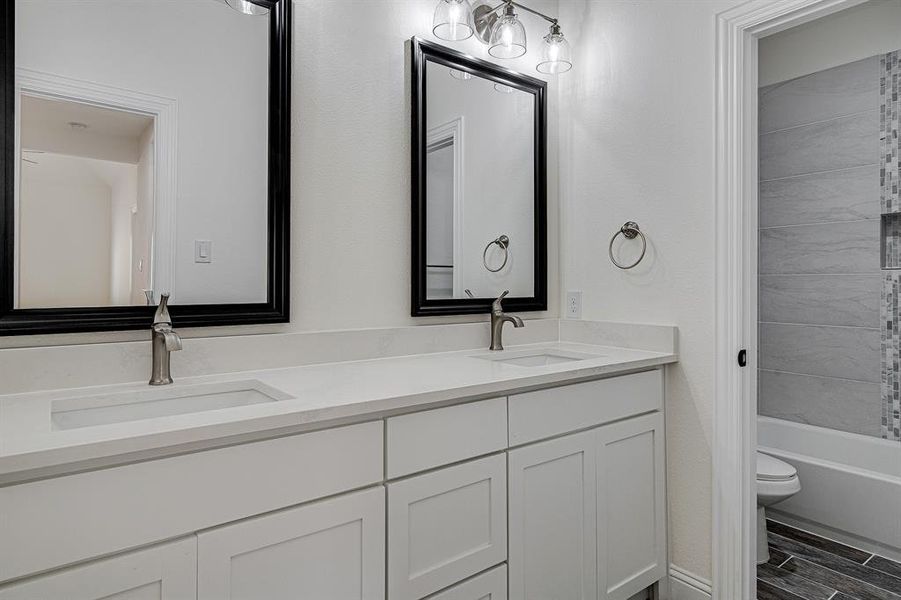 Full bathroom with vanity, toilet, and bathtub / shower combination