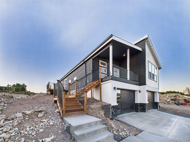 Daytime view of the home highlighting the elevated lot, fresh landscaping potential, and clean curb appeal. Daytime view of the home highlighting the elevated lot, fresh landscaping potential, and clean curb appeal.