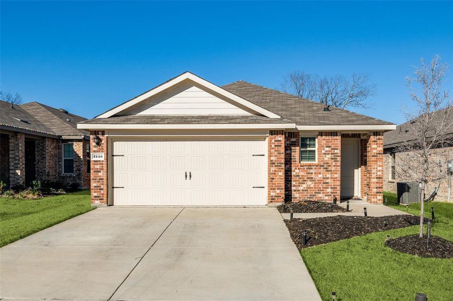 Ranch-style house with a front lawn, concrete driveway, brick siding, and an attached garage