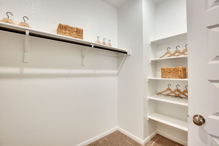A white shelving unit with a basket and a basket on it. A white shelving unit with a basket and a basket on it.