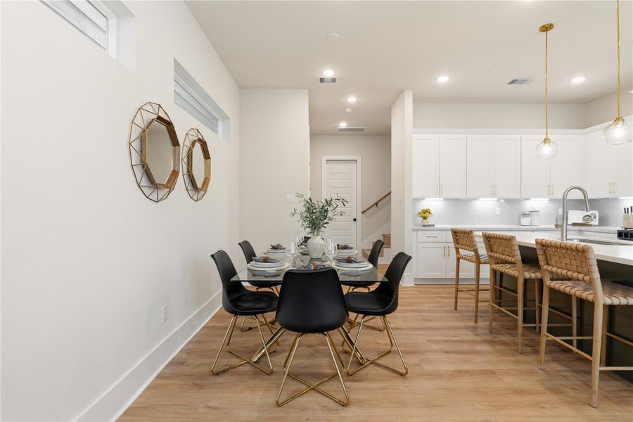 A defined dining space that integrates effortlessly with the kitchen, positioned directly off the island to enhance flow. Generous proportions allow for seating up to six, ideal for both intimate meals and larger gatherings. A defined dining space that integrates effortlessly with the kitchen, positioned directly off the island to enhance flow. Generous proportions allow for seating up to six, ideal for both intimate meals and larger gatherings.