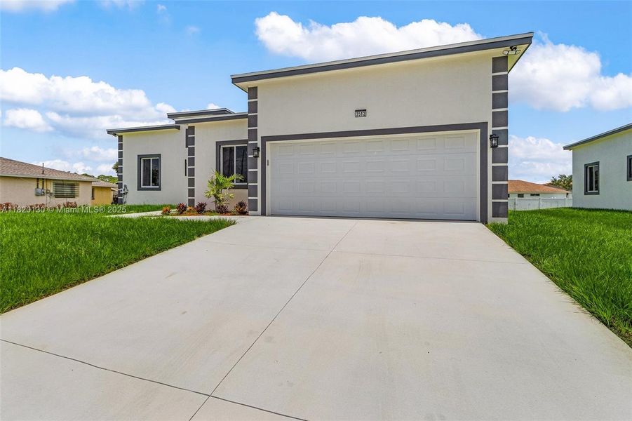 Front exterior of a new home in , Lehigh Acres, FL, highlighting curb appeal (Image 17).