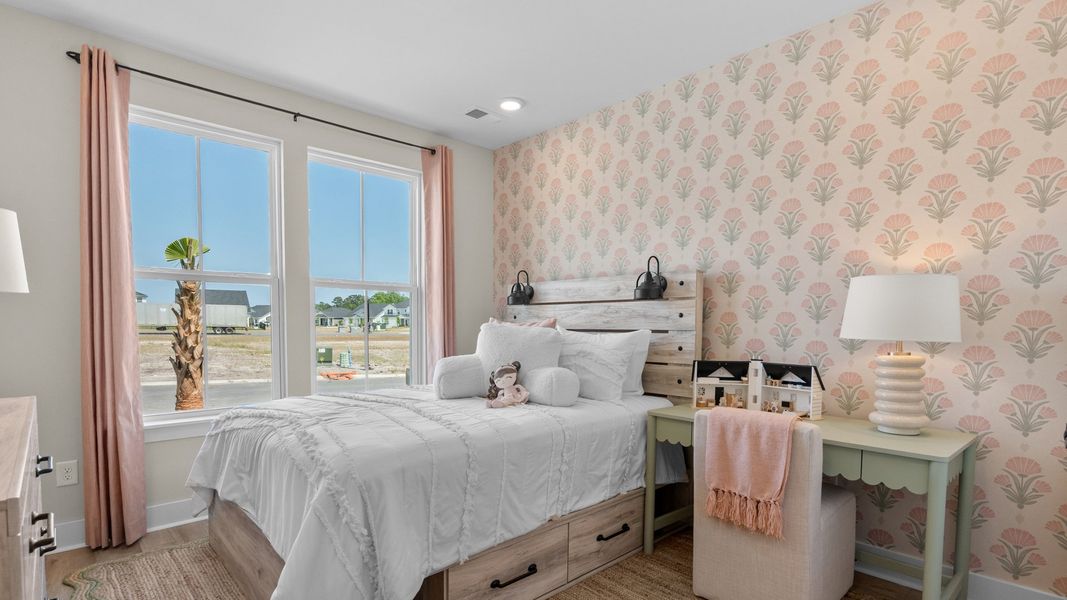 First-floor secondary bedroom in the Summit home plan with comfort and natural light.