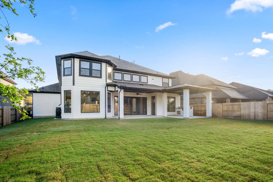 Exterior details and patio area of a home in ARTAVIA 70′ Lots, Conroe (Image 28).