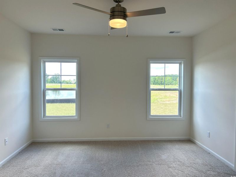 Unfurnished room featuring carpet floors and plenty of natural light
