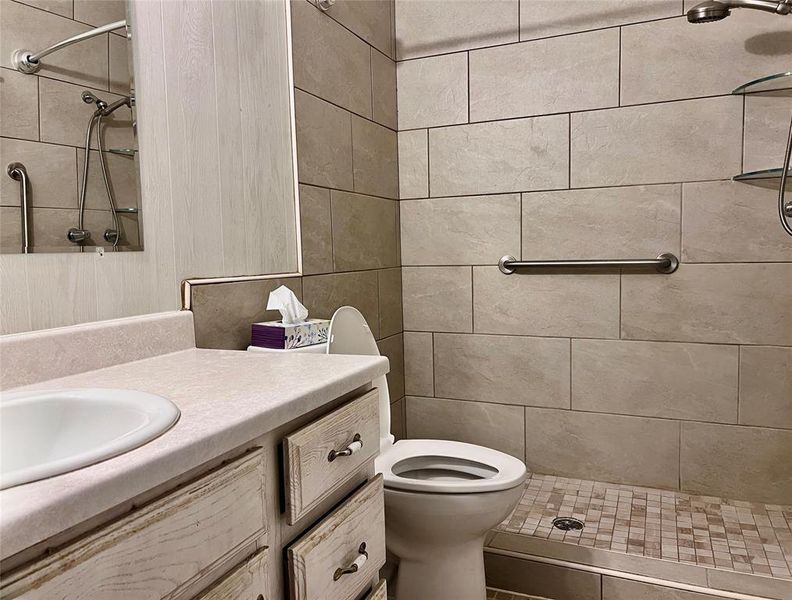 Full bath with vanity and tiled shower Full bath with vanity and tiled shower