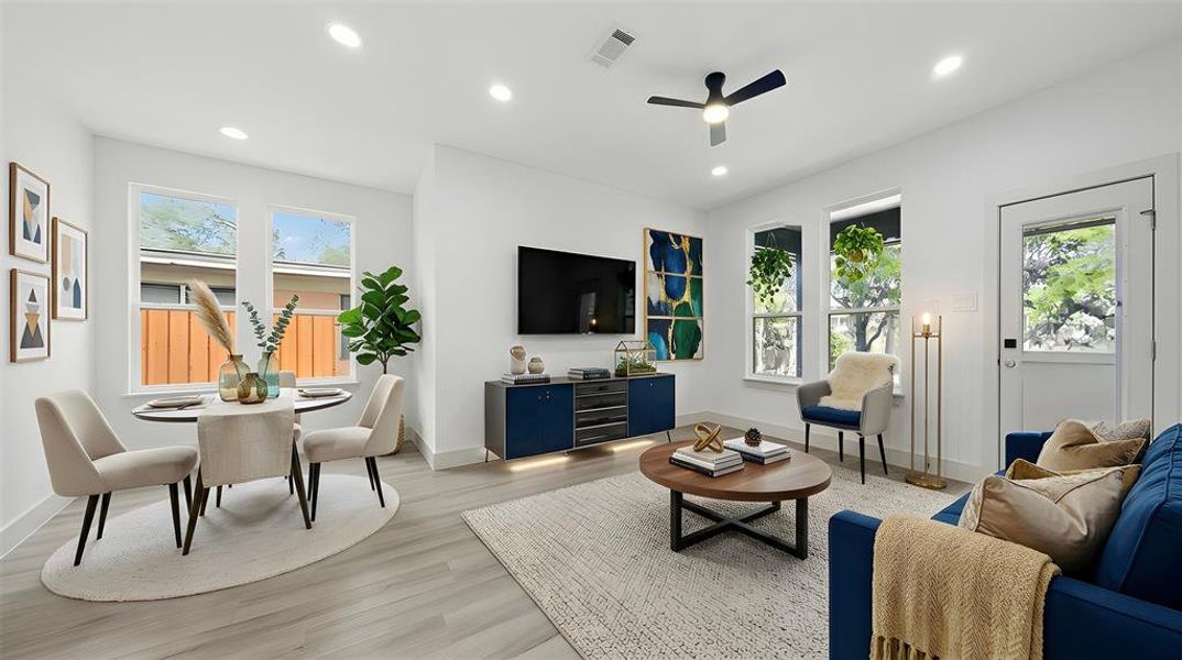 Living room featuring a ceiling fan, recessed lighting, and light wood-style floors