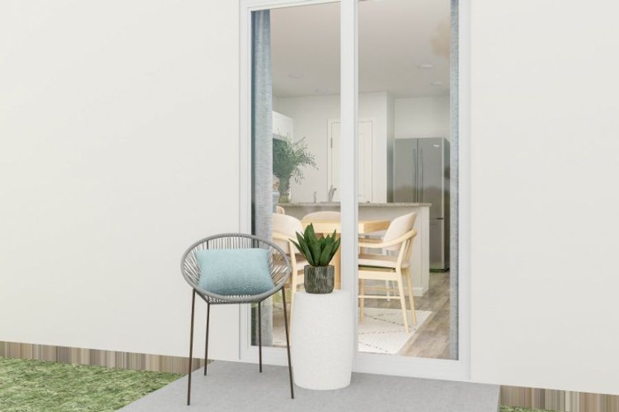 A room with a table chairs and a planter.