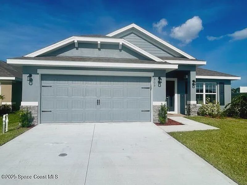 Front exterior of a new home in St. John Preserve, Palm Bay, FL, highlighting curb appeal (Image 1). Front exterior of a new home in St. John Preserve, Palm Bay, FL, highlighting curb appeal (Image 1).
