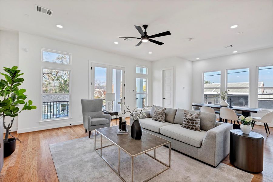 Bright and airy, this spacious living room is filled with natural light streaming through large glass windows, creating a warm and inviting atmosphere. (Representation of previously built homes. Actual colors and finishes will vary.) Bright and airy, this spacious living room is filled with natural light streaming through large glass windows, creating a warm and inviting atmosphere. (Representation of previously built homes. Actual colors and finishes will vary.)