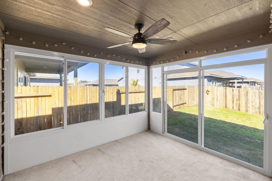 Unfurnished sunroom with ceiling fan Unfurnished sunroom with ceiling fan