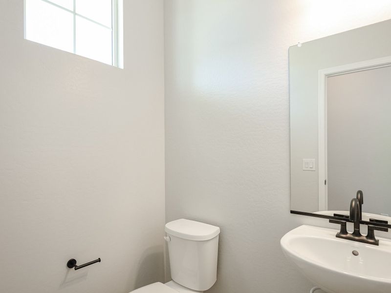 A bathroom with a toilet and sink. A bathroom with a toilet and sink.