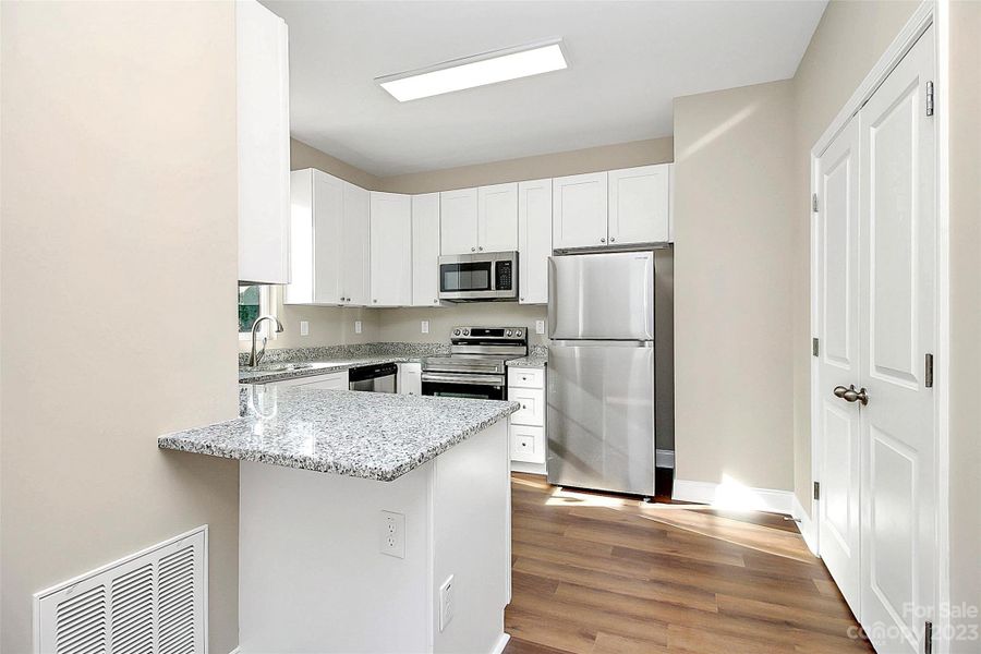 Kitchen has granite countertops and stainless steel appliances.