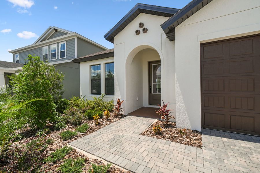 Front exterior of a new home in Avalon West, Spring Hill, FL, highlighting curb appeal (Image 6).
