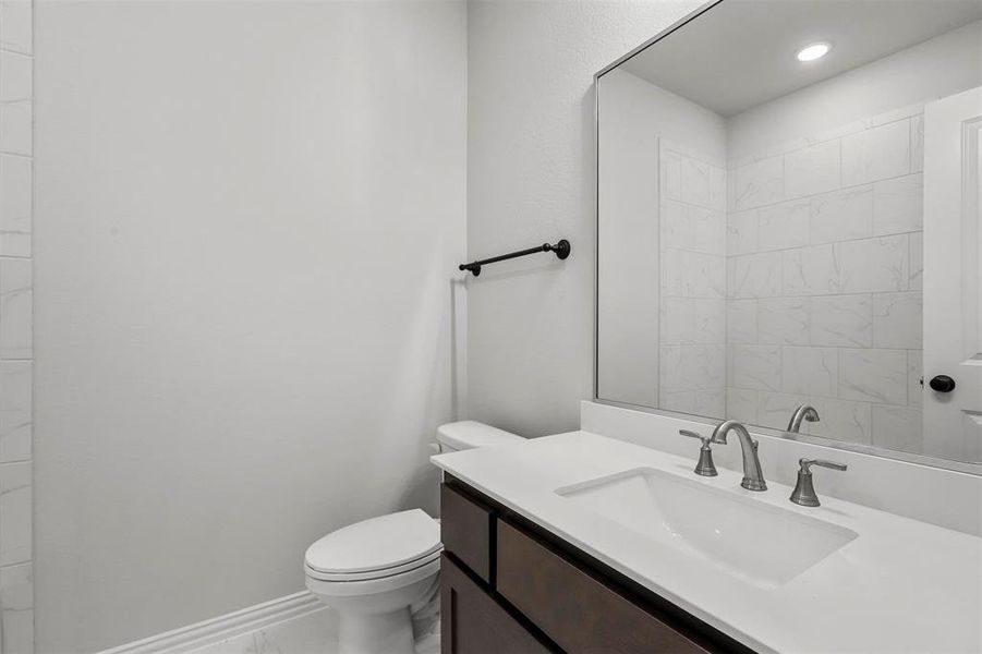 Bathroom with tile patterned floors, toilet, and vanity