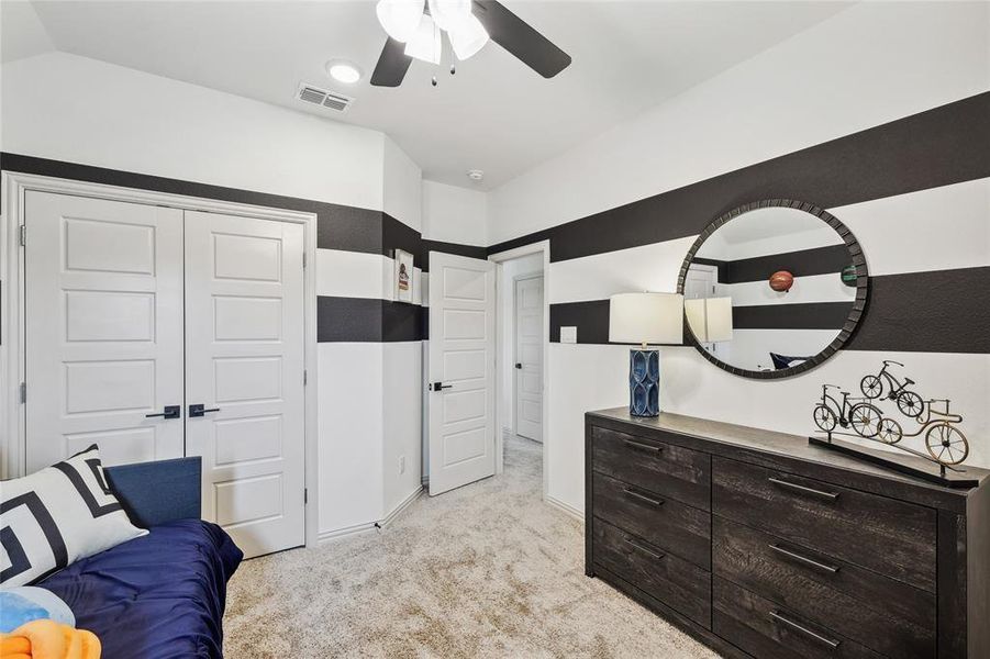 Carpeted bedroom featuring a closet and ceiling fan