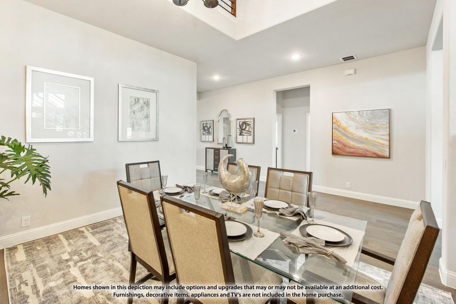 Dining room with glass table, six upholstered chairs, hardwood floors, and tray ceiling with chandelier